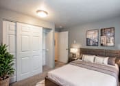 Thumbnail 1 of 12 - a bedroom with a bed and a closet
