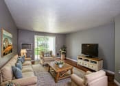 Thumbnail 9 of 12 - a living room with a couch and a television