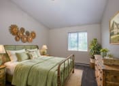 Thumbnail 33 of 34 - a bedroom with a bed and a painting on the wall
