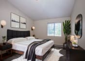 Thumbnail 30 of 34 - a bedroom with a bed and a potted plant