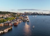 Thumbnail 23 of 23 - Liza Apartments aerial view of South Lake Union with boats and a city in the background at Liza Apartments, Washington