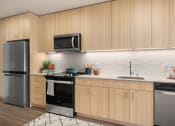 Thumbnail 1 of 19 - a kitchen with wooden cabinets and stainless steel appliances at The Hemlock, Seattle, WA