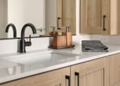 Thumbnail 4 of 23 - a kitchen with a sink and a black faucet at Liza Apartments, Washington