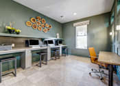 Thumbnail 13 of 20 - A room with a green wall and a wooden table.