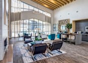 Thumbnail 7 of 20 - A modern living room with a large window and a wooden ceiling.