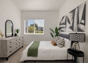 Thumbnail 2 of 12 - a bedroom with a bed and a dresser and a window