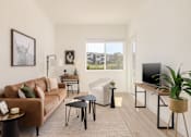 Thumbnail 4 of 12 - a living room with a brown couch and a television