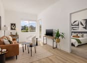 Thumbnail 3 of 12 - a living room with a couch and a tv and a bedroom with a bed