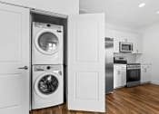 Thumbnail 10 of 12 - a white laundry room with a washer and a dryer