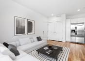 Thumbnail 8 of 12 - a living room with white couches and a coffee table