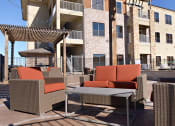 Thumbnail 17 of 27 - a patio with chairs and a table in front of a building at Urban Square, Texas, 76210