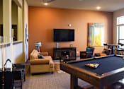 Thumbnail 21 of 27 - a living room with a pool table and a television at Urban Square, Denton, TX, 76210
