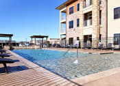 Thumbnail 14 of 27 - a swimming pool with a building in the background at Urban Square, Denton, Texas
