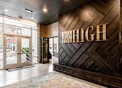 Thumbnail 20 of 27 - The lobby of a building with a large sign at 985 High Apartments, Columbus, 43201