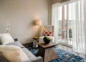 Thumbnail 14 of 27 - A living room with a grey couch and a wooden coffee table. at 985 High Apartments, Columbus, 43201