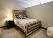Thumbnail 16 of 27 - A bedroom with a bed, nightstand, and lamp. at 985 High Apartments, Columbus, OH, 43201