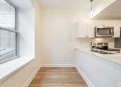 Thumbnail 9 of 20 - a spiral staircase with white walls and wood floors