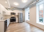 Thumbnail 2 of 20 - an empty kitchen with stainless steel appliances and a large window