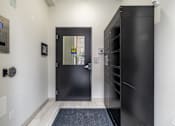 Thumbnail 16 of 20 - a black door in a white hallway with a black front door