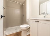 Thumbnail 7 of 20 - a bathroom with a toilet and a tub and a sink