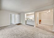 Thumbnail 1 of 25 - A spacious room with a carpeted floor and white walls.