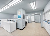 Thumbnail 17 of 25 - A laundromat with washers and dryers.