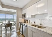Thumbnail 8 of 66 - Newly updated kitchen with sleek white cabinets and granite countertops at CityView on Meridian, Indiana, 46208