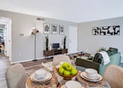Thumbnail 6 of 38 - A dining room with a table set for two and a bowl of apples in the center.
