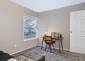 Thumbnail 13 of 38 - A room with a desk and chair in it.