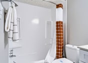 Thumbnail 19 of 38 - A white bathroom with a towel rack and a toilet.