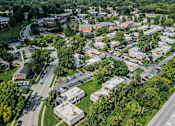 Thumbnail 36 of 38 - A bird's eye view of a small town with a mix of residential and commercial buildings.