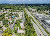 Thumbnail 34 of 38 - A bird's eye view of a suburban area with houses, trees, and a highway.