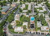 Thumbnail 35 of 38 - A bird's eye view of a residential area with a swimming pool.