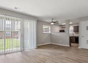 Thumbnail 7 of 25 - Room with ceiling fan and kitchen view at Lexington Square, Kentucky
