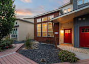 Thumbnail 16 of 61 - A house with a red door and a wooden front porch. at Verraso Village Apartments, Meridian