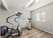 Thumbnail 72 of 73 - A home gym with a treadmill, elliptical trainer, and a vacuum cleaner.