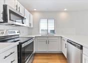 Thumbnail 15 of 48 - Kitchen with appliances, cabinets and counter top at River Walk Apartments, Idaho