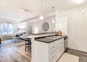 Thumbnail 10 of 35 - a kitchen with white cabinets and a sink and a counter top at Corso Apartments, Missoula, MT