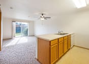 Thumbnail 6 of 31 - an empty kitchen with a sink and a ceiling fan