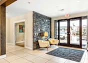 Thumbnail 22 of 35 - the lobby of a hotel with two chairs and a rug at Corso Apartments, Missoula, MT
