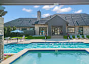 Thumbnail 2 of 60 - a swimming pool with a house in the background at The Vineyards of Colorado Springs, Colorado Springs