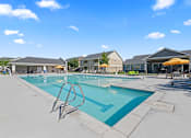 Thumbnail 27 of 40 - A large outdoor swimming pool with a diving board.