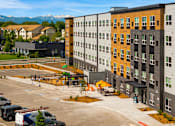 Thumbnail 91 of 98 - A parking lot with a building in the background at The Beaumont Apartments, Montana, 59715