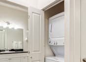 Thumbnail 9 of 35 - a laundry room with a washer and dryer and a door to the bathroom at Corso Apartments, Missoula, MT