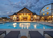 Thumbnail 43 of 46 - A large house with a pool in front of it.