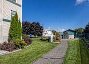 Thumbnail 13 of 31 - a yard in front of a house with a driveway and a yard with a yard