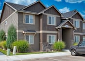 Thumbnail 11 of 28 - A grey car is parked in front of a two-story house.