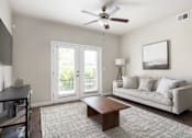 Thumbnail 17 of 26 - a living room with a couch coffee table and a ceiling fan at The Alloy at Geneva, Vineyard, 84058