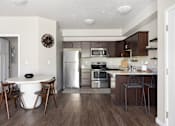 Thumbnail 15 of 26 - a kitchen and dining area in a 555 waverly unit at The Alloy at Geneva, Utah, 84058