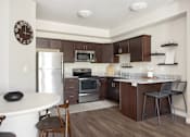 Thumbnail 19 of 26 - a kitchen with a refrigerator freezer and a stove top oven at The Alloy at Geneva, Vineyard, UT